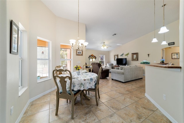 dining space with visible vents, baseboards, light tile patterned floors, ceiling fan with notable chandelier, and high vaulted ceiling