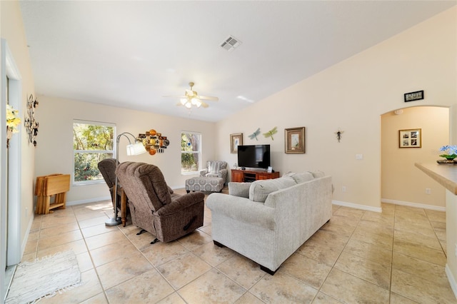 living room featuring visible vents, ceiling fan, lofted ceiling, light tile patterned flooring, and arched walkways