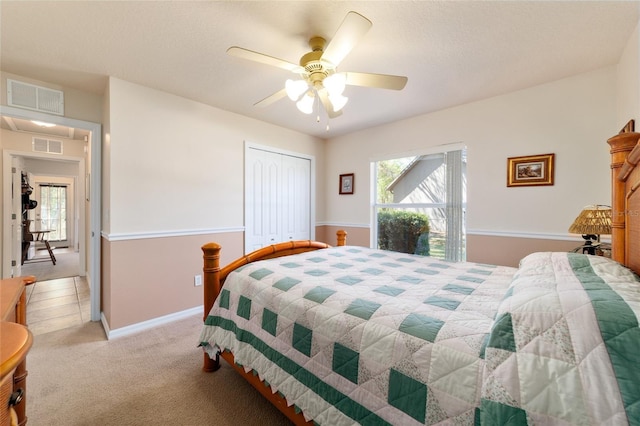 bedroom with visible vents, light carpet, and multiple windows