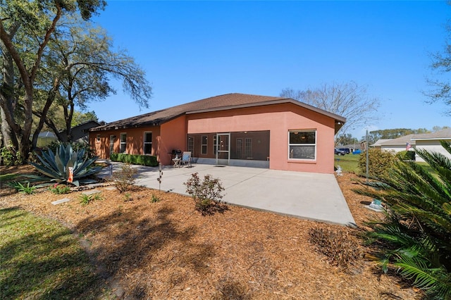 back of house featuring stucco siding and a patio