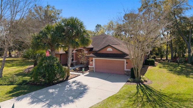 view of front of home featuring stucco siding, a front lawn, stone siding, concrete driveway, and an attached garage