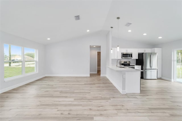 kitchen with stainless steel appliances, white cabinetry, visible vents, and light countertops