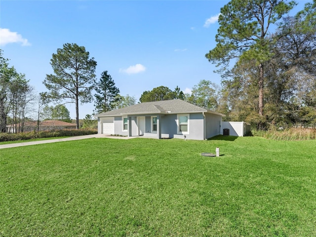 view of front of property with stucco siding, a front lawn, fence, concrete driveway, and an attached garage