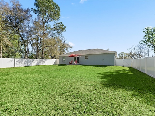 view of yard with a fenced backyard