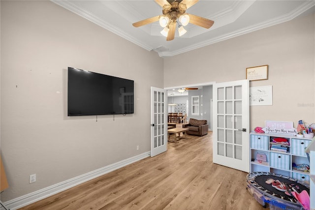 playroom with a ceiling fan, wood finished floors, french doors, and ornamental molding