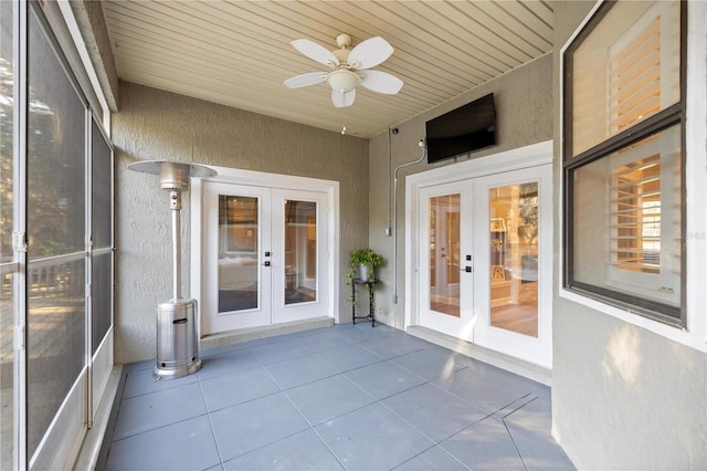 unfurnished sunroom with french doors, wood ceiling, and a ceiling fan