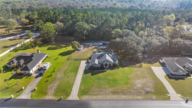 birds eye view of property with a wooded view