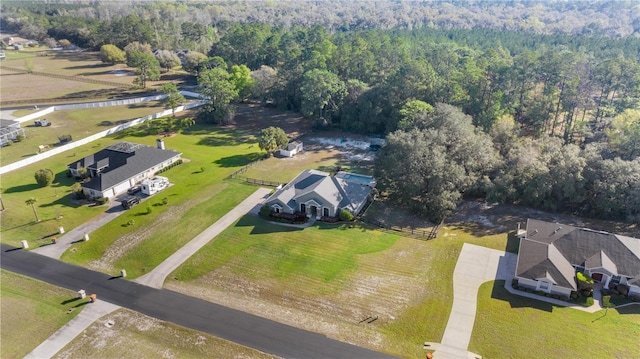 birds eye view of property with a view of trees