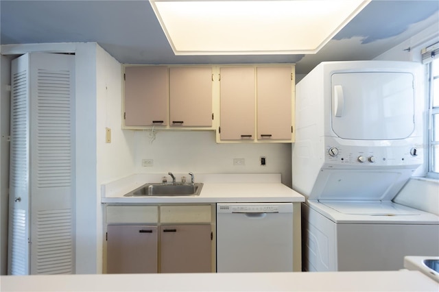 washroom featuring laundry area, stacked washer and clothes dryer, and a sink