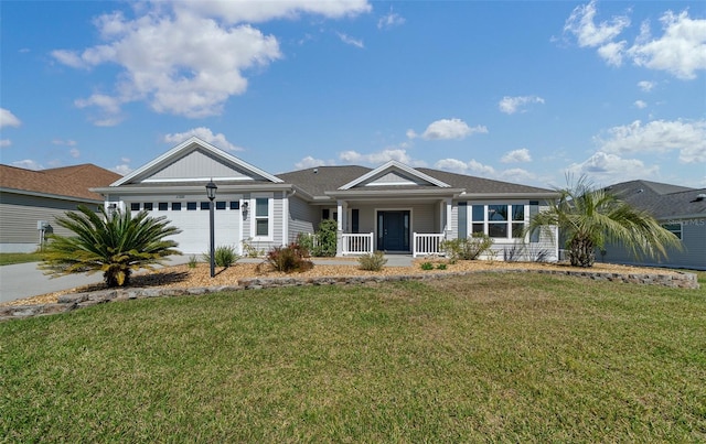 view of front of house featuring a garage, a porch, concrete driveway, and a front yard