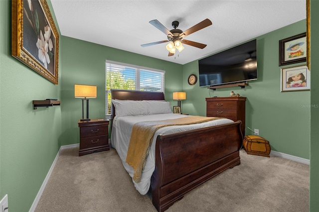 carpeted bedroom featuring a ceiling fan and baseboards