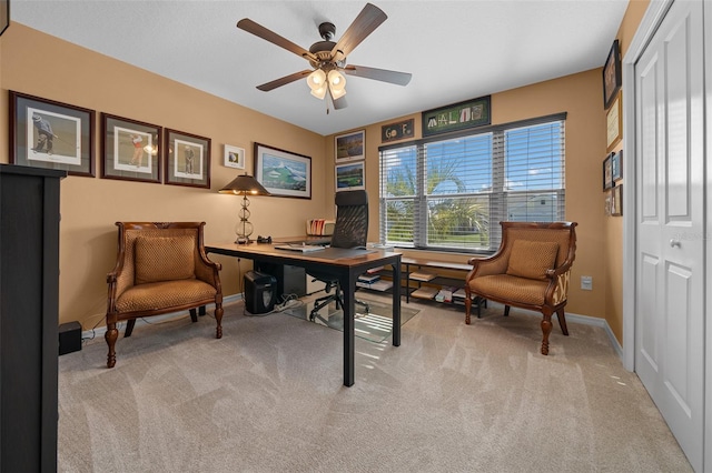 office space featuring baseboards, ceiling fan, and carpet flooring