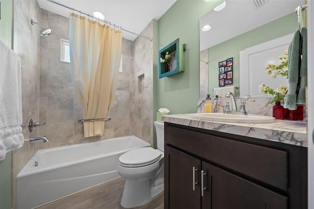 full bathroom with shower / bath combo with shower curtain, toilet, wood finished floors, and vanity