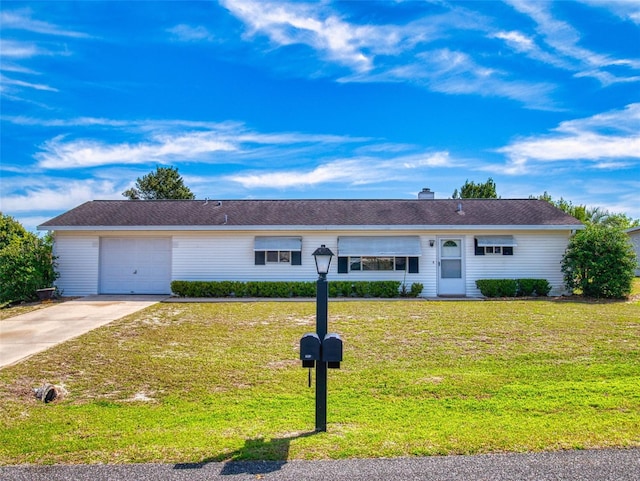 single story home with a chimney, driveway, an attached garage, and a front yard