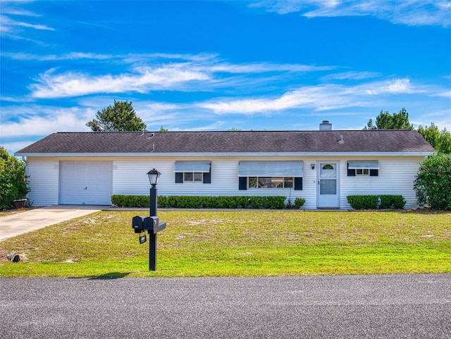 single story home featuring a garage, a chimney, concrete driveway, and a front lawn