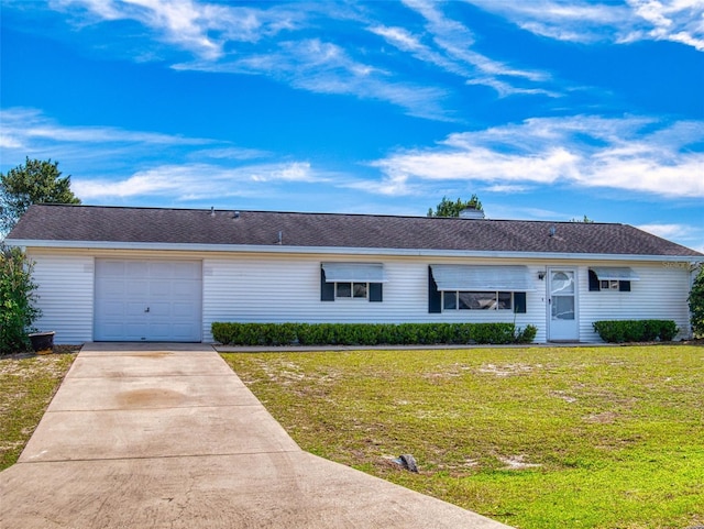 ranch-style house featuring an attached garage, concrete driveway, and a front yard