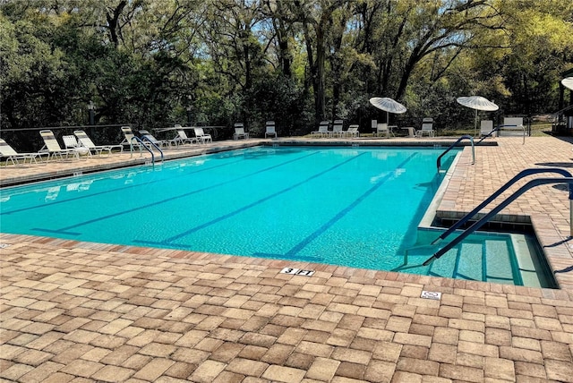 community pool with a patio area