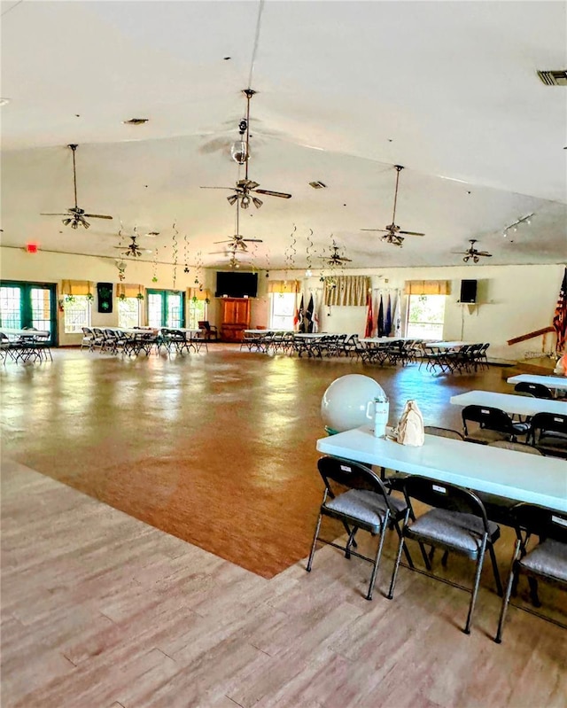 dining area with lofted ceiling, a ceiling fan, visible vents, and a healthy amount of sunlight