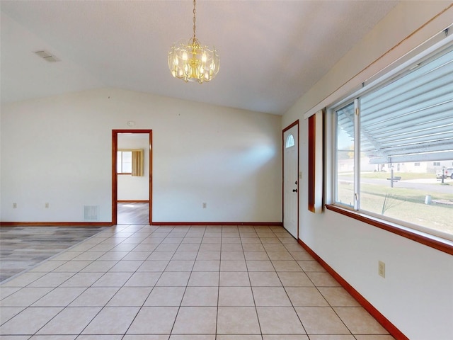 11197 SW 79th Ave, Ocala, FL 34476 - unfurnished room with a chandelier, lofted ceiling, baseboards, and light tile patterned floors