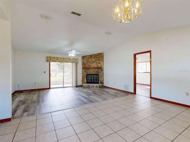 11197 SW 79th Ave, Ocala, FL 34476 - unfurnished living room featuring a ceiling fan, lofted ceiling, a chandelier, a fireplace, and light wood-style floors
