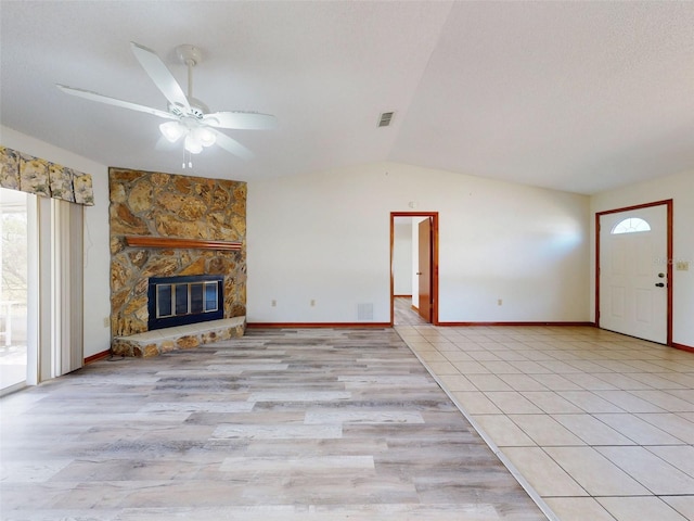 11197 SW 79th Ave, Ocala, FL 34476 - unfurnished living room with lofted ceiling, a fireplace, baseboards, a ceiling fan, and light wood-style floors