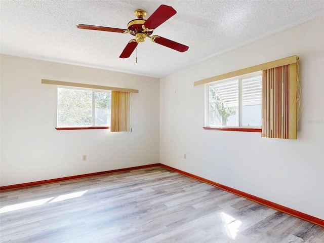 11197 SW 79th Ave, Ocala, FL 34476 - spare room with wood finished floors, ceiling fan, baseboards, and a textured ceiling