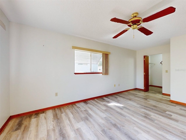 11197 SW 79th Ave, Ocala, FL 34476 - empty room with wood finished floors, ceiling fan, and baseboards