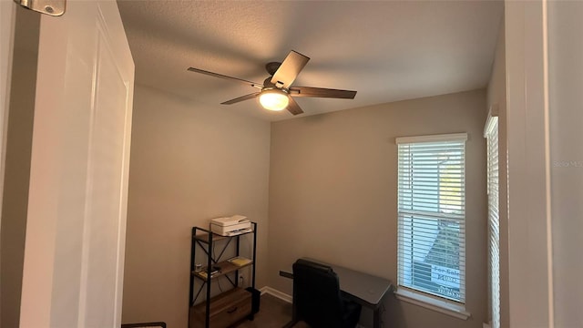 office with a ceiling fan and a textured ceiling