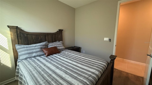 bedroom with wood finished floors and baseboards