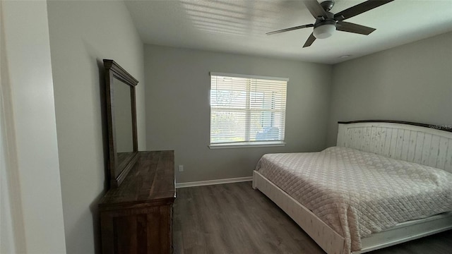 bedroom with baseboards, wood finished floors, and a ceiling fan