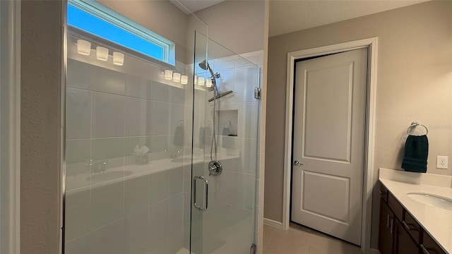 full bathroom with vanity, a shower stall, and tile patterned flooring