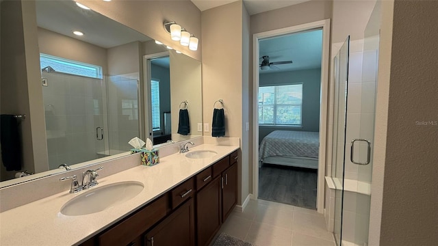 bathroom featuring a healthy amount of sunlight, a stall shower, and a sink