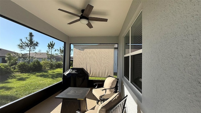 sunroom / solarium with a ceiling fan