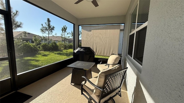 sunroom / solarium with a healthy amount of sunlight and a ceiling fan