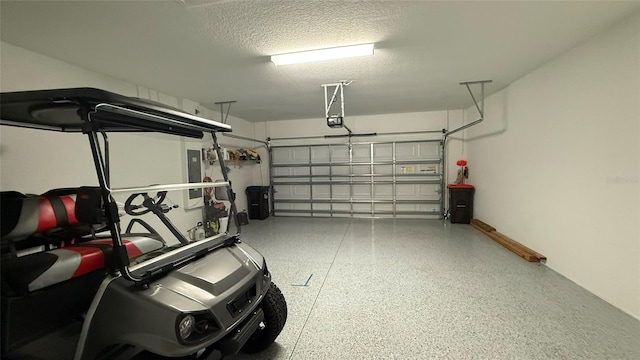 garage featuring electric panel and a garage door opener