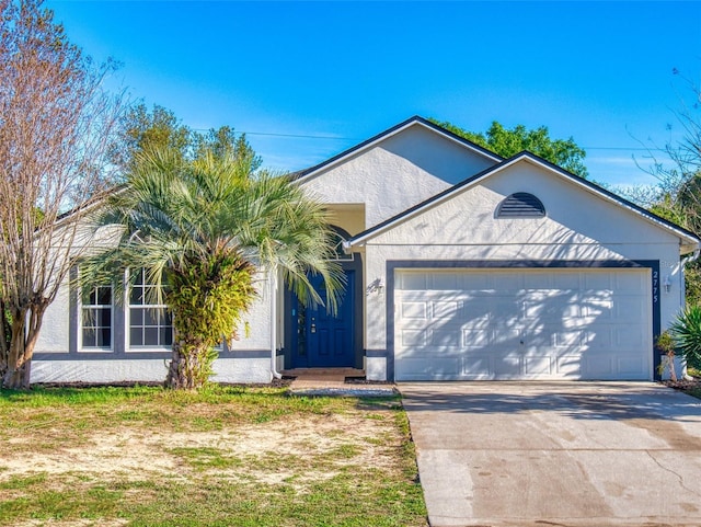 ranch-style home with stucco siding, driveway, and an attached garage