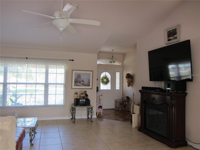 living room with light tile patterned floors, a ceiling fan, and visible vents