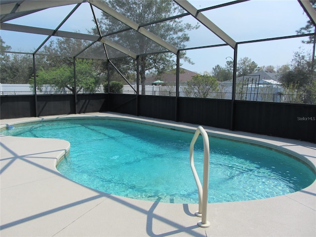 view of swimming pool featuring a fenced in pool, a lanai, and fence