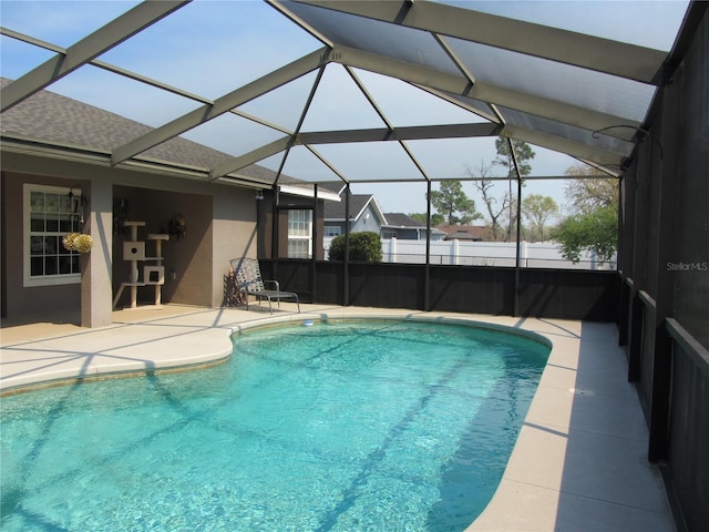 view of swimming pool featuring a fenced in pool, a lanai, and a patio area