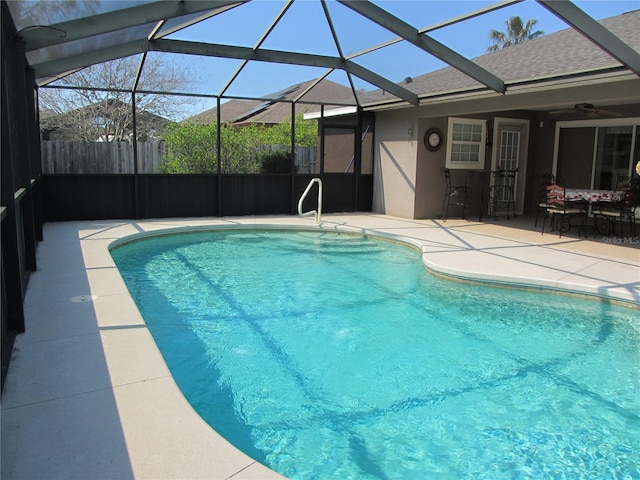 view of pool featuring a patio, a fenced in pool, fence, and a lanai