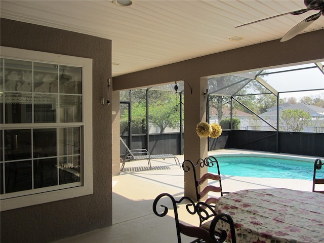 outdoor pool with ceiling fan, a patio, and a lanai