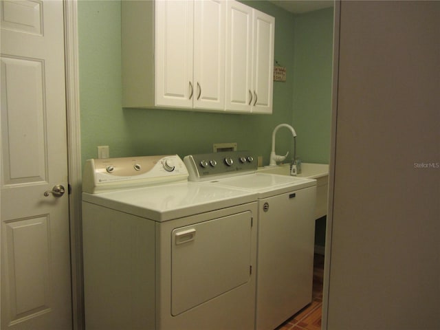 laundry room with cabinet space and washer and clothes dryer