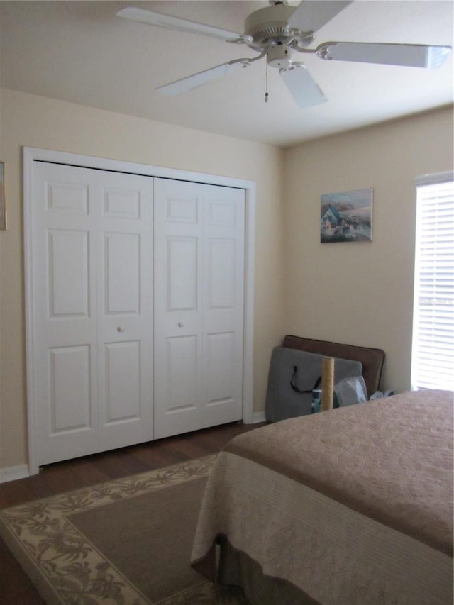 bedroom with baseboards, wood finished floors, a closet, and ceiling fan