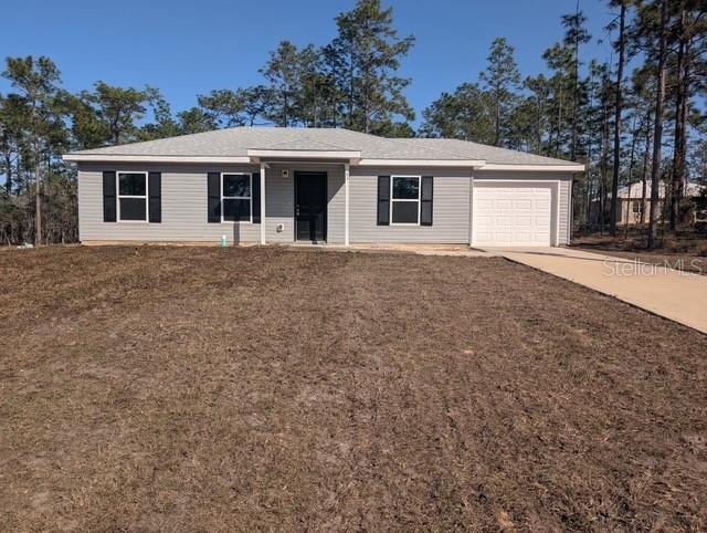 single story home with driveway and a garage