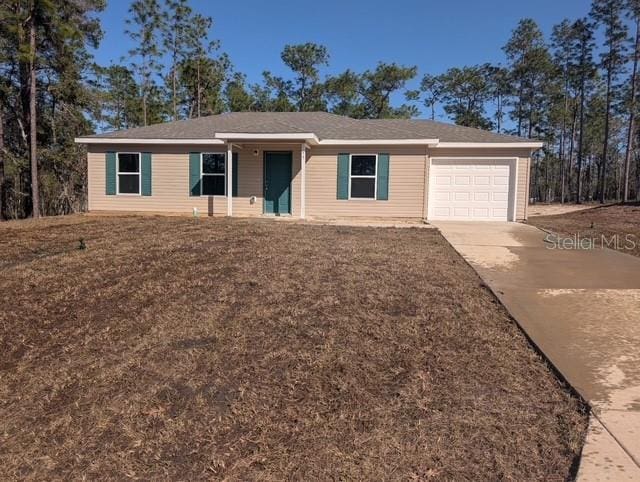 ranch-style home featuring concrete driveway and an attached garage