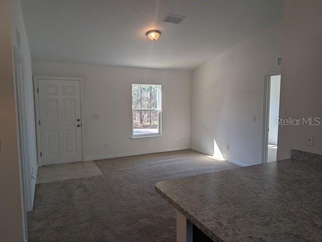 interior space with carpet flooring and visible vents