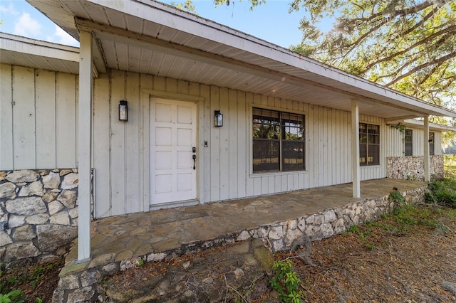 9951 NE 30th Ct, Anthony, FL 32617 - doorway to property featuring stone siding and board and batten siding