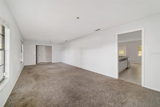 9951 NE 30th Ct, Anthony, FL 32617 - spare room featuring light tile patterned flooring, visible vents, and light colored carpet