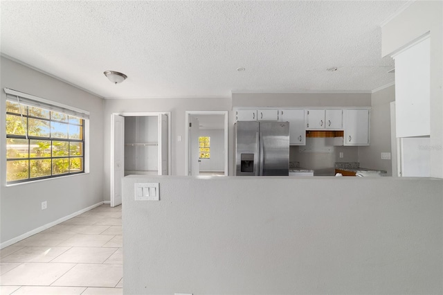9951 NE 30th Ct, Anthony, FL 32617 - kitchen with white cabinetry, light countertops, a peninsula, and stainless steel fridge with ice dispenser