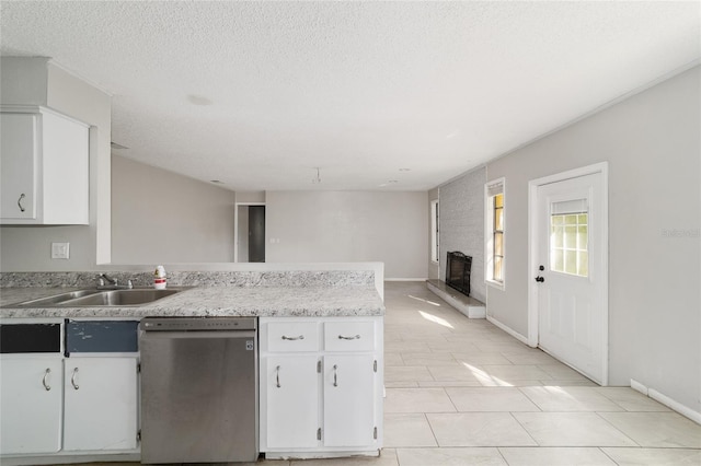 9951 NE 30th Ct, Anthony, FL 32617 - kitchen with light countertops, a sink, dishwasher, a peninsula, and white cabinets